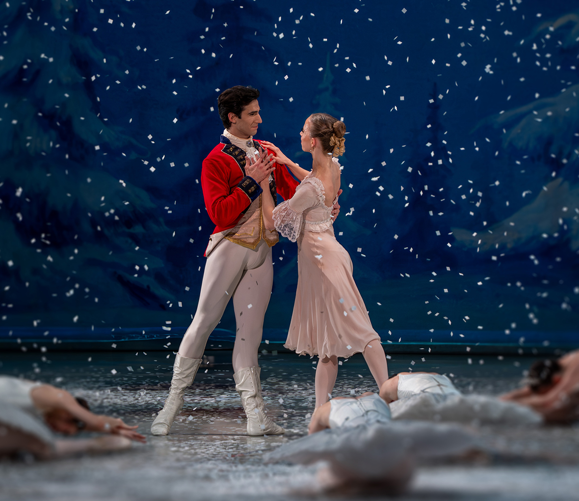 Male and female dancer dancing in snow scene. The gazing lovingly into each others eyes.