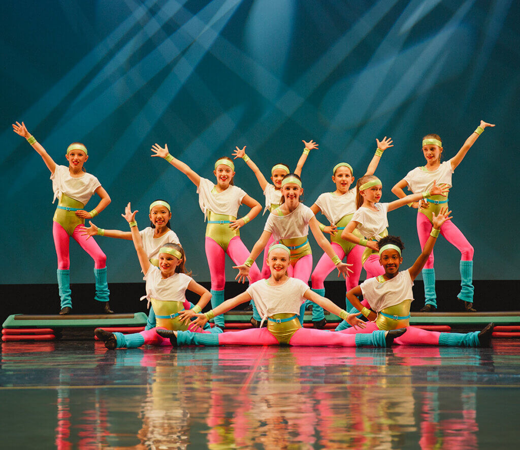 Group of young girls performing on stage 